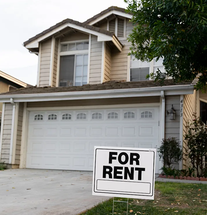 House with a For Rent sign in the front yard